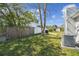 The Backyard features a grassy area and a grill on the patio, ideal for outdoor activities at 7553 Sequoia Dr, New Port Richey, FL 34653