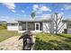 Backyard with screened patio and a grill, ideal for outdoor gatherings and relaxation at 7553 Sequoia Dr, New Port Richey, FL 34653