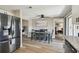 Bright dining area featuring stainless steel appliances, hardwood floors and an open view into the living room at 7553 Sequoia Dr, New Port Richey, FL 34653