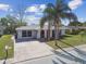 Inviting single-Gathering home with palm trees, arched windows, long driveway, and manicured lawn in a sunny neighborhood at 7553 Sequoia Dr, New Port Richey, FL 34653