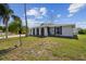 Charming single-story home with stucco exterior, arched entrance, and well-manicured front yard at 7553 Sequoia Dr, New Port Richey, FL 34653
