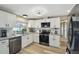 Bright kitchen features stainless appliances, granite counters and hardwood floors at 7553 Sequoia Dr, New Port Richey, FL 34653
