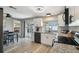 Modern kitchen featuring white cabinetry, granite countertops, stainless steel appliances, and an open view to the dining area at 7553 Sequoia Dr, New Port Richey, FL 34653