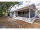 A view of the backyard with the screen-protected patio attached to the house at 7830 Judith Cres, Port Richey, FL 34668
