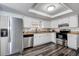 Well-lit kitchen with stainless steel appliances and white cabinets at 7830 Judith Cres, Port Richey, FL 34668