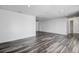 Expansive living area with sleek wood-look floors, fresh paint, and recessed lighting, perfect for entertaining at 7830 Judith Cres, Port Richey, FL 34668