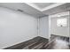 A view into the room featuring gray walls, gray wood-look floors, and white doors at 7830 Judith Cres, Port Richey, FL 34668