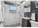 Contemporary bathroom featuring dark walls, a glass-enclosed shower, and a stylish vanity with sleek hardware at 818 37Th Ne Ave, St Petersburg, FL 33704