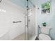 Modern bathroom featuring a glass-enclosed shower, white tiles, and stylish fixtures at 818 37Th Ne Ave, St Petersburg, FL 33704