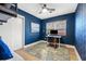 Blue bedroom with wood floors, a desk, and a blue rug at 818 37Th Ne Ave, St Petersburg, FL 33704