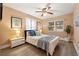 Cozy bedroom with a ceiling fan, hardwood floors, and lots of natural light from the windows at 818 37Th Ne Ave, St Petersburg, FL 33704