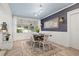 Charming dining room featuring a dark wood table, patterned wallpaper, and natural light at 818 37Th Ne Ave, St Petersburg, FL 33704