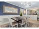Elegant dining room with dark wood table, white chairs, and patterned blue wallpaper at 818 37Th Ne Ave, St Petersburg, FL 33704