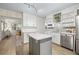 Modern kitchen with white cabinetry, stainless steel appliances, center island, and stylish backsplash at 818 37Th Ne Ave, St Petersburg, FL 33704