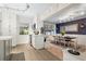 Open kitchen view with stainless steel appliances and dining area with patterned wallpaper at 818 37Th Ne Ave, St Petersburg, FL 33704