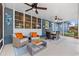 Relaxing screened-in patio with lounge area, ceiling fans, and an outdoor dining space at 818 37Th Ne Ave, St Petersburg, FL 33704