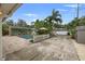 Private pool area with umbrellas, seating and lush landscaping, perfect for relaxation at 818 37Th Ne Ave, St Petersburg, FL 33704