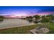 Picturesque waterfront view with a bench, calm water, and stunning sunset colors at 818 37Th Ne Ave, St Petersburg, FL 33704