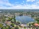 Aerial view of the home's location close to a lake and surrounded by lush greenery at 8305 Palma Vista Ln, Tampa, FL 33614