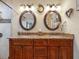 This bathroom has granite counters, dual sinks, mirrors and hardwood cabinetry at 8305 Palma Vista Ln, Tampa, FL 33614