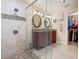 This bathroom has granite counters, dual sinks, a tile shower and walk in closet at 8305 Palma Vista Ln, Tampa, FL 33614