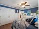 This bedroom has blue accent walls and hardwood flooring with a white closet at 8305 Palma Vista Ln, Tampa, FL 33614