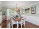 Elegant dining room with hardwood floors, decorative chandelier, and lots of natural light at 8305 Palma Vista Ln, Tampa, FL 33614