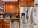 Kitchen featuring stainless steel refrigerator, custom cabinets, granite countertops, and beverage cooler at 8305 Palma Vista Ln, Tampa, FL 33614