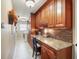 Functional laundry room featuring granite countertops, custom cabinetry, and modern appliances at 8305 Palma Vista Ln, Tampa, FL 33614