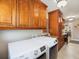 Bright laundry area with modern washer and dryer, custom cabinets and granite countertops at 8305 Palma Vista Ln, Tampa, FL 33614
