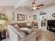 Spacious living room with cozy sectional couch, ceiling fan, and decorative art on the walls at 8305 Palma Vista Ln, Tampa, FL 33614