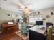 Charming home office featuring hardwood floors, ceiling fan and desk workspace at 8305 Palma Vista Ln, Tampa, FL 33614