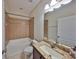 A bright bathroom featuring tile, a shower and tub combo, and a granite vanity at 838 Vino Verde Cir, Brandon, FL 33511