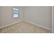 A bright bedroom with neutral carpet and a window overlooking the backyard at 838 Vino Verde Cir, Brandon, FL 33511