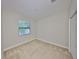 Neutral bedroom featuring a large window and carpeted floor at 838 Vino Verde Cir, Brandon, FL 33511