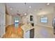 Open kitchen and living area showcasing a granite island, stainless appliances, and an eat-in dining area at 838 Vino Verde Cir, Brandon, FL 33511