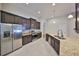 Kitchen featuring stainless steel appliances, granite countertops, dark wood cabinets, and recessed lighting at 838 Vino Verde Cir, Brandon, FL 33511