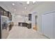 Well-appointed kitchen featuring stainless appliances, dark cabinets, granite counters, and tile floors at 838 Vino Verde Cir, Brandon, FL 33511