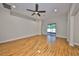 Spacious living room featuring wood flooring, recessed lighting, and sliding glass doors to a screened patio at 838 Vino Verde Cir, Brandon, FL 33511