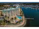 An aerial showcases Boca Ciega's resort-style living, including a pool, dock, and serene waterfront views at 8800 Bay Pines Blvd # 303, St Petersburg, FL 33709