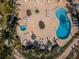 Overhead view of the swimming pool, hot tub, and seating area with palm tree accents at 8800 Bay Pines Blvd # 303, St Petersburg, FL 33709