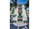 Building entrance into Boca Ciega complex with well-maintained landscaping at 8800 Bay Pines Blvd # 303, St Petersburg, FL 33709