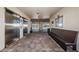 An elevator lobby that leads to outdoor spaces with a bench and tile flooring at 8800 Bay Pines Blvd # 303, St Petersburg, FL 33709