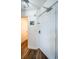 A bright entryway with laminate floors and a white door, leading to other rooms at 8800 Bay Pines Blvd # 303, St Petersburg, FL 33709
