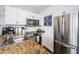 This kitchen features stainless appliances, granite countertops and white cabinets at 8800 Bay Pines Blvd # 303, St Petersburg, FL 33709