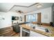 Open floorplan featuring a breakfast bar overlooking the living room and a beautiful lake view at 8800 Bay Pines Blvd # 303, St Petersburg, FL 33709
