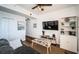 Well-lit living room featuring stylish decor, wood floors, and access to other rooms at 8800 Bay Pines Blvd # 303, St Petersburg, FL 33709