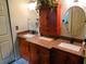 Bathroom featuring double vanity sinks with cabinetry and decorative mirrors at 8810 41St N St, Pinellas Park, FL 33782