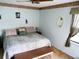 Bedroom with queen sized bed, bench, and a decorated wall mirror at 8810 41St N St, Pinellas Park, FL 33782