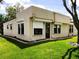 Single-story home featuring tidy landscaping, roll-down shutters, and a well-maintained lawn at 8810 41St N St, Pinellas Park, FL 33782